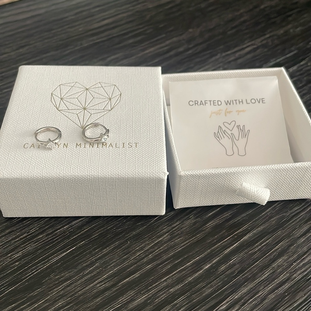 Silver hoop earrings by Caitlyn Minimalist.